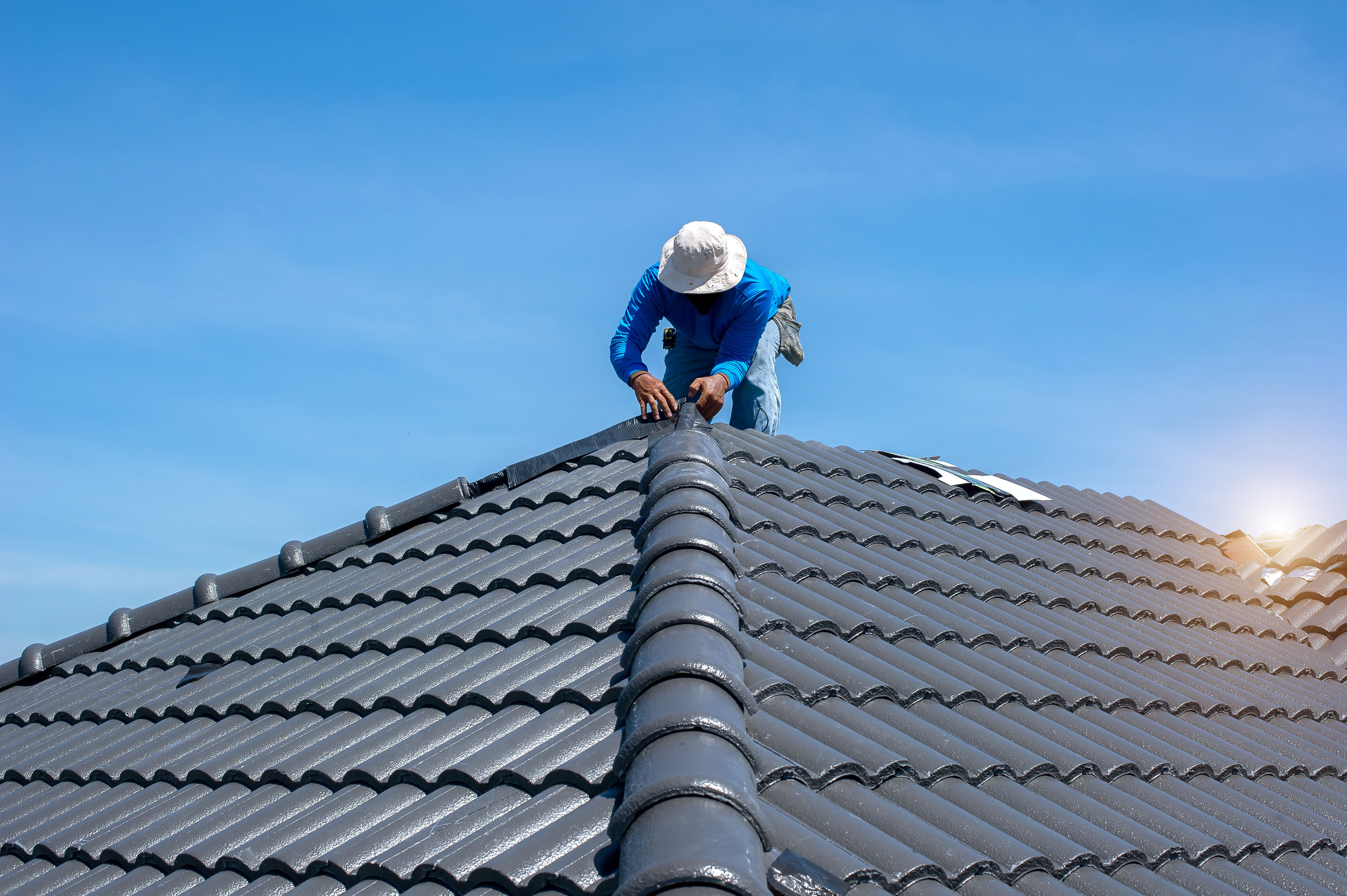 Roofer completing a roof installation
